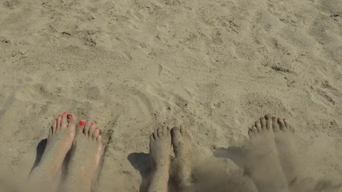 Bare feet of a family on the shore. | Stock Video | Pond5