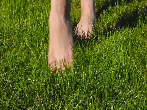 Bare feet on the grass Stock Footage 76796793