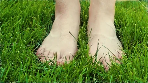 Bare feet on the grass Stock Footage 76997631