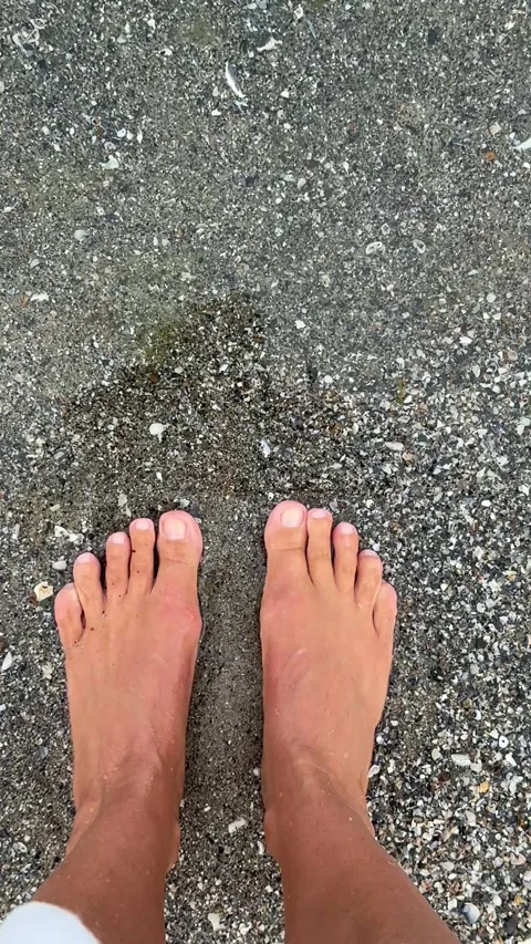 Bare feet on pebble beach at water's edge in Odesa Stock Footage 339730650