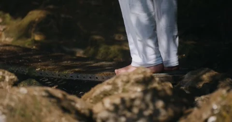 Bare feet positioned on green moss rocks next to safety grid in Ötschergräben Stockbeeldmateriaal 325955398