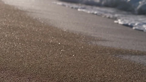 Bare feet of woman walking along wet sandy beach Stock Footage