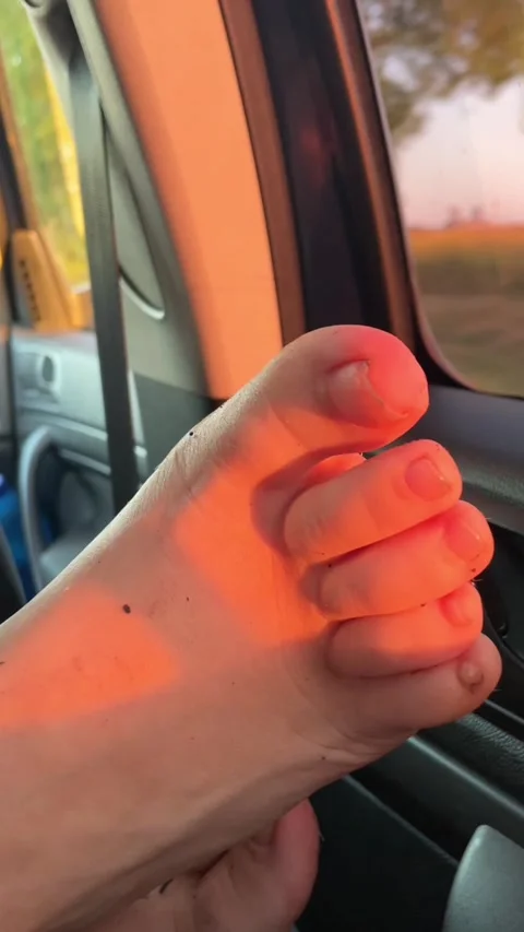 Bare foot shifting beside car window in warm sunset light inside quiet cabin Stock Footage 341662836