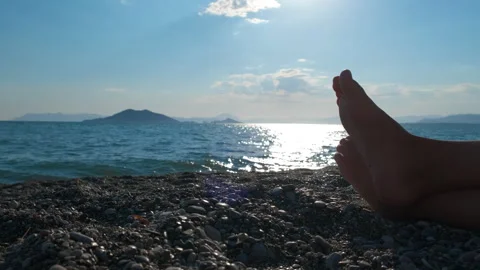 Bare legs on pebbles against waves Stock Footage 299659281