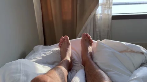 Bare Male Legs Resting On White Bed Sheets Stock Footage 345712906