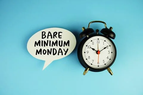 Bare Minimum Monday text on speech bubble with alarm clock on blue background Stock Photos