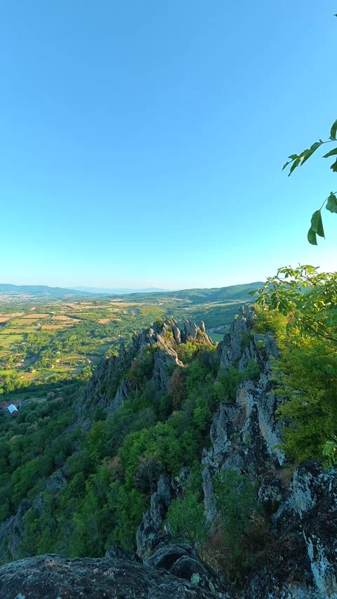 Bare rock juts into clear blue sky. Boracki krs Serbia Vertical 動画素材 345006126