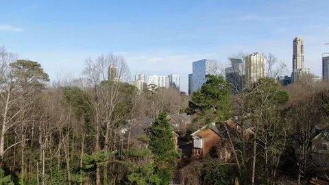 Bare trees and homes below the Buckhead skyline in Atlanta Stock Footage 104261966