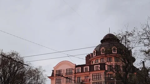 Bare trees in the foreground in a suburban area, a city of European type. The Stock Footage 75631893