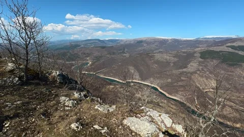 Bare trees frame a rugged hilltop view. Balkan, Eastern Europe, POV Video stock 331813989