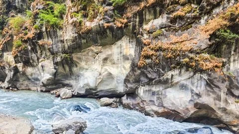 Bare vertical cliffs above the river. Photos