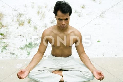 Barechested Man Sitting In Lotus Position, High Angle View