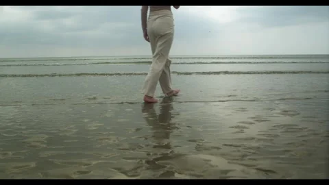 Barefeet on the beach, walking through the waves 4k Video stock 297207790