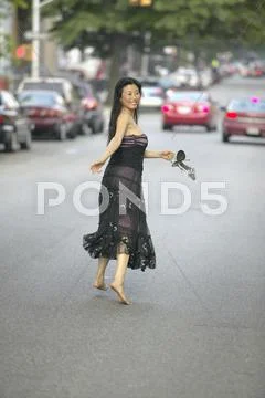 Barefoot Asian Woman In Evening Gown Running In Street