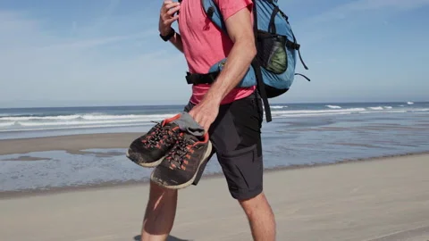 Barefoot Bald Man Walking on Beach at Sunrise in Portugal Stock Footage 337763454