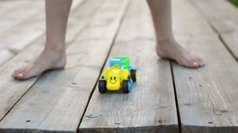 Barefoot Child Having Fun with Toy Car on Wooden Playground HD Stock Footage 34208067