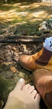 Barefoot on the edge of a stream Stock Photos