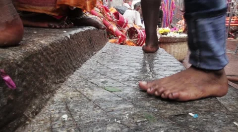 Barefoot feet in street in India Stock Footage