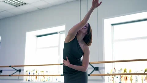 Barefoot female dancer is engaged in ballet improvisation moving gracefully Stock Footage 343875806