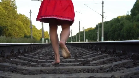 Barefoot girl running on railway Stock Footage