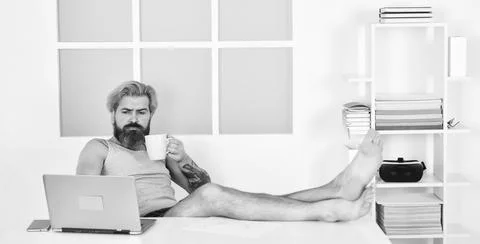 Barefoot guy working from home. Developer work computer. Social networks Stock Photos