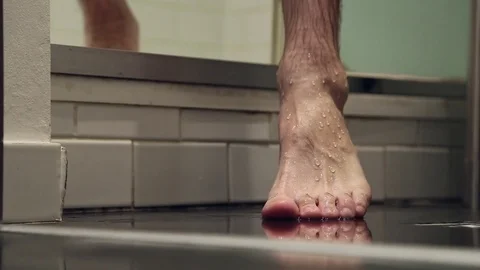 Barefoot human foot stepping on bathroom floor Stock Footage 76484687