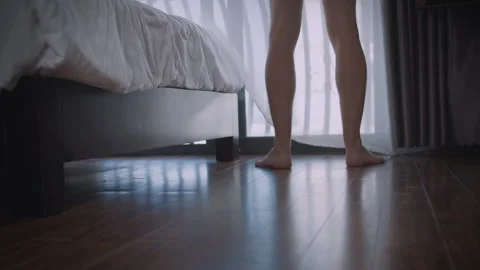 Barefoot Man Steps Across Floor to Window Stockbeeldmateriaal 334320371