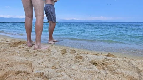 Barefoot man steps on beach sand near turquoise sea Stock Footage 341753055