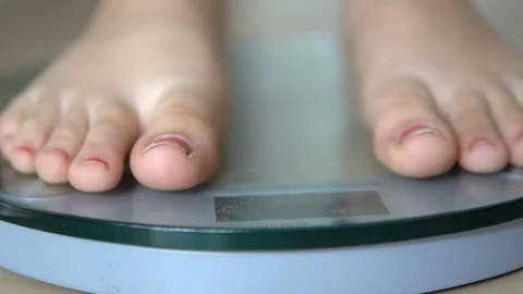 Woman On Scales Measure Weight. Girl Leg, Stock Video