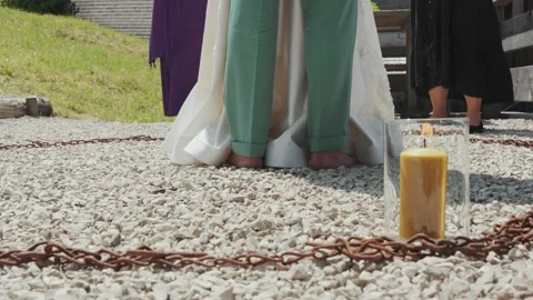 Barefoot Wedding Couple Doing a Ritual with Burning Candle Stock Footage 312584124