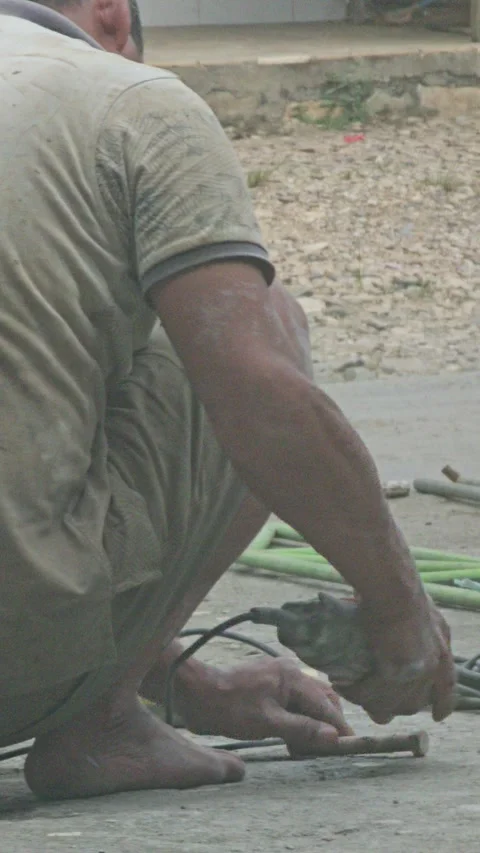 Barefoot Worker Cutting Metal With Angle Grinder Causing Sparks Stock Footage 340199544