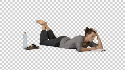 Barefooted guy lies on the grass and reads book. Green screen footage Stock Footage 48337038