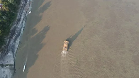 Barge boat moving on the Amazon River in Iquitos, Peru, with muddy water at Stock Footage 304445336