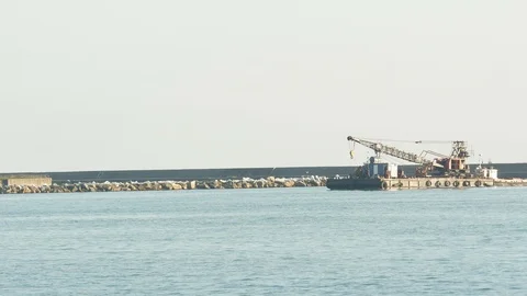 Barge Crane pushed by a tugboat in the harbor waters Stock Footage 125353076