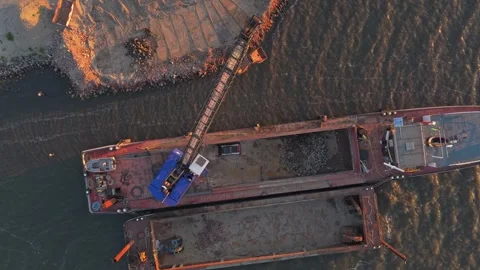 Barge crane unloading rocks for dike reinforcement construction Stock-Footage 342809194