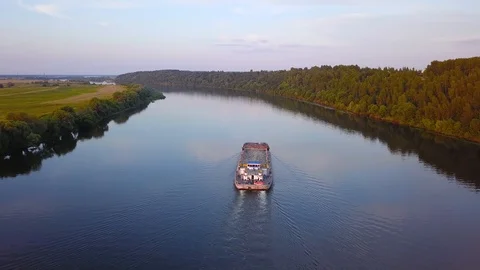 Barge with empty container floats along river along banks with trees Stock Footage 97784203