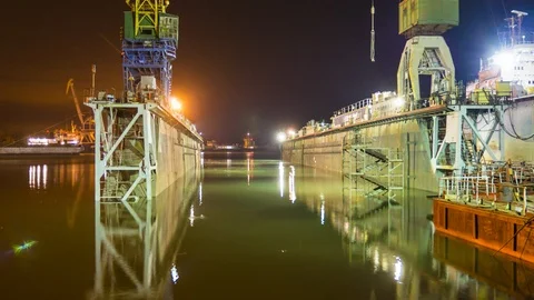 The barge enters the dock, then it is lowered and the barge is in the dry dock. Stock-Footage 86783458