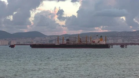 Barge Floating in Open Sea, Not Far From Coast With Small City Stock Footage 65393297