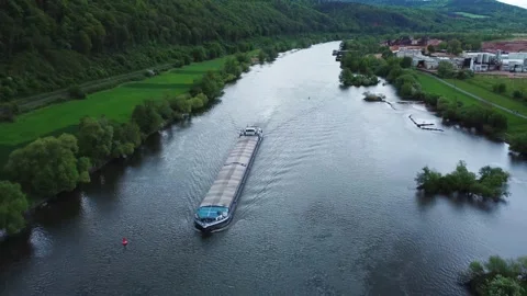 The barge floats on the river next to the hill and forest Stock Footage 154376201
