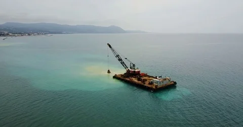 Barge lifts the sand using a ladle from the bottom of the sea. Stock Footage 76272957