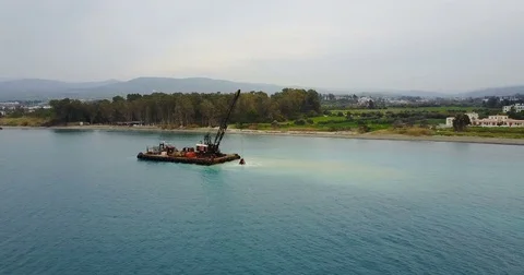 Barge lifts the sand using a ladle from the bottom of the sea Stock Footage 76856816