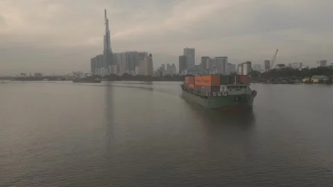 A barge loaded with shipping containers slowly floats down a river Video stock 296593045
