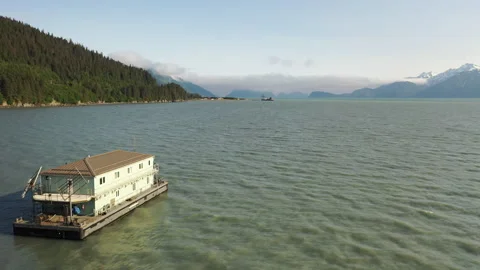 Barge mobile float camp on an inlet on the Kenai Peninsula Stock Footage 240171308