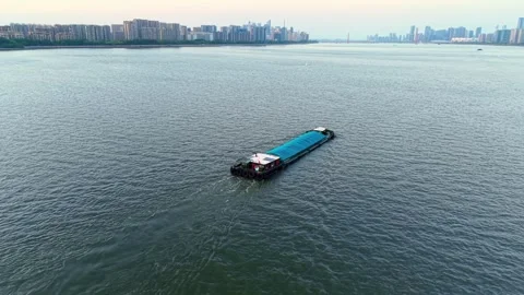 Barge navigating the river waters of China during a calm day. Stock Footage 308844168