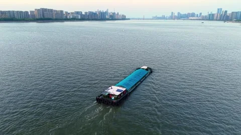 Barge navigating the river waters of China during a calm day. 스톡 동영상 309094063