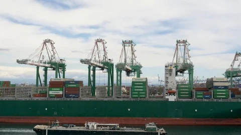 Barge passing container ship being loaded-unloaded Stock-Footage 106866128