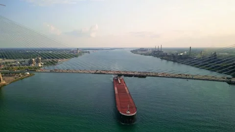 A barge passing through slowly under newly constructed Gordie Howe Internat.. Stock Footage 313679423