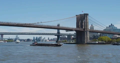A Barge Pushed Under the Brooklyn Bridge Stock Footage 108317455