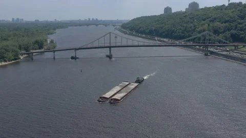 Barge on the river overlooking the pedestrian bridge in Kyiv Stock Footage 193780158