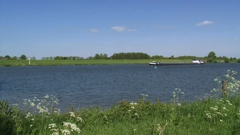 Barge sailing downstream the river IJssel + pan Stock Footage 107531207